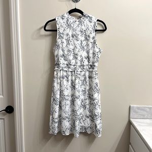 White smoked mini dress with blue and yellow flowers.  Size M